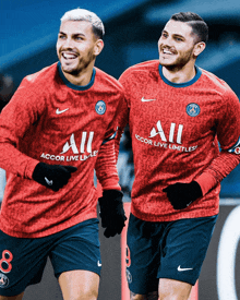 two soccer players wearing red and blue jerseys that say accor live limitless