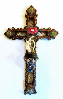 a cross with a red rose and a skeleton on it