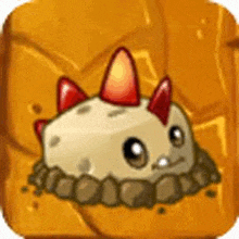 a cartoon character with red spikes on its head is sitting on a rock .