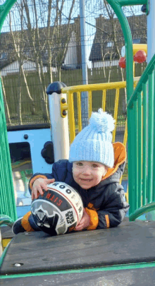 a little boy is holding a star wars ball