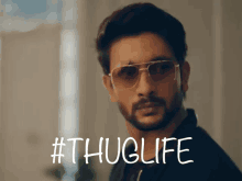 a man wearing sunglasses with the hashtag #thuglife on the bottom