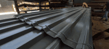 a stack of metal roofing is sitting on a table