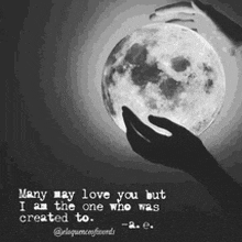 a black and white photo of a person holding a full moon with a quote