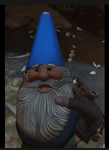 a gnome with a beard and a blue hat is giving a thumbs up