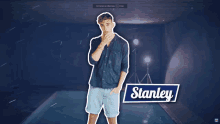 a man standing in front of a pool with a stanley sticker on his chest