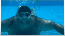 a man wearing a swim cap and goggles is swimming in the water