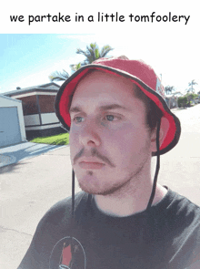 a man wearing a red hat with the words " we partake in a little tomfoolery " below him