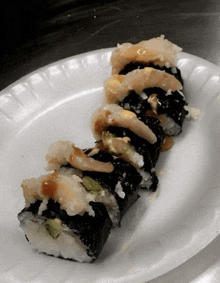 a close up of a sushi roll on a white plate