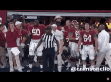 a group of football players are standing in front of a referee wearing a jersey with the number 50 on it