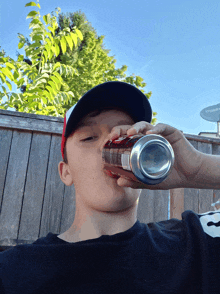 a boy is drinking from a can that says coca cola