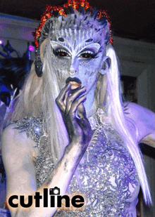 a picture of a woman with blue face paint and the words cutline below her