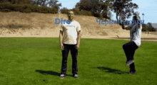 a man in a dirt shirt is standing in the grass