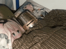 a knight 's helmet is laying on a bed with a pillow with a girl on it