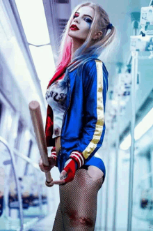 a woman in a harley quinn costume is holding a baseball bat