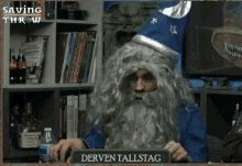 a man in a wizard costume is holding a sign that says derven tallstad