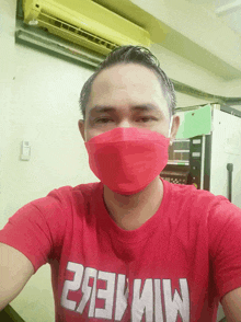 a man wearing a red mask and a red shirt that says miner2