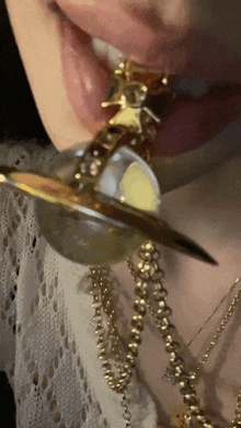 a close up of a woman 's mouth with a necklace on