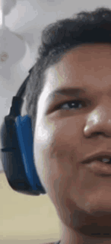 a close up of a man wearing headphones and making a funny face .