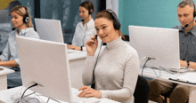 a woman wearing a headset is sitting in front of a computer monitor