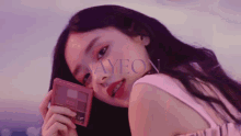 a close up of a woman holding a makeup palette with ayeon written in the corner