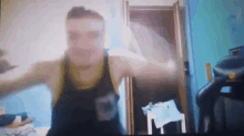 a blurry picture of a man in a black tank top with the letter n on it