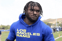 a man in a blue los angeles rams hoodie