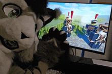 a furry character playing a video game on a computer