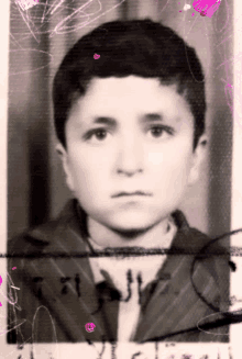 a black and white photo of a young boy with the letters a and j visible