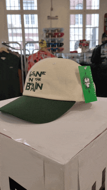 a green and white hat that says sane in the bain