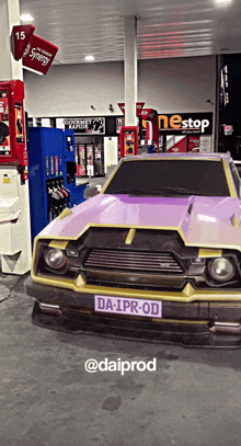 a purple car with a license plate that says da-ipr-od is parked in a gas station