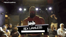 a wrestler named rex lawless is standing on a stage