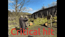 two men are standing in front of a wooden fence with the words " critical hit " written in red