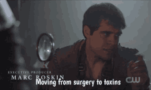 a man says moving from surgery to toxins while looking through a magnifying glass