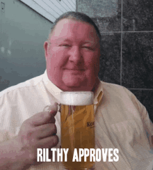 a man holding a glass of beer with the words rilthy approves below him