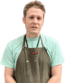 a man wearing a green apron and a teal shirt