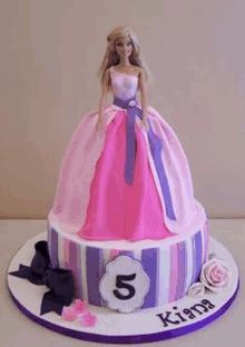 a pink and purple cake with a barbie doll on top