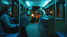 a blurry picture of a bus with a person sitting in the middle