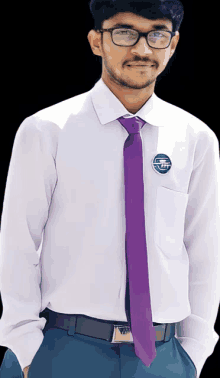 a man wearing a white shirt and a purple tie has a badge on his shirt that says tpt