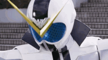 a close up of a white robot with blue eyes and a yellow antenna