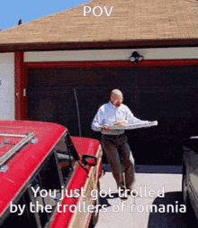 a man is carrying a tray of food in front of a garage door with the caption " you just got trolled "