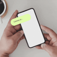 a person is holding a cell phone with a yellow sticker that says catalog isi