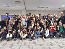 a group of people posing for a picture with one wearing a green shirt that says ' philippines ' on it