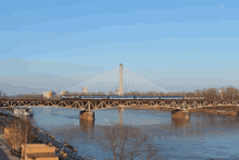 a bridge over a body of water with a train going over it