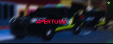 a blurry picture of cars with the word apertura in red letters