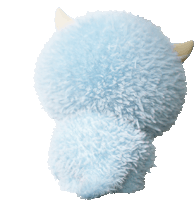 a light blue stuffed animal with horns is sitting on a white surface