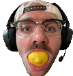 a man wearing headphones and a hat is holding a yellow ball in his mouth .