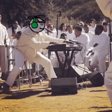 a man is playing a keyboard in front of a crowd of people