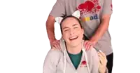 a man is giving a woman a massage while wearing a cat ear headband .