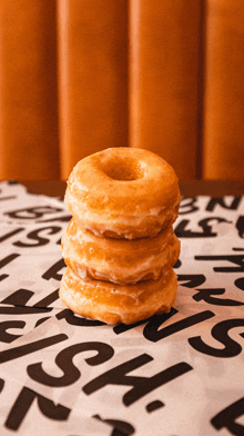 three donuts are stacked on top of each other on a table