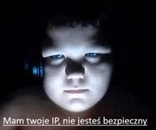 a boy with headphones on looks at the camera with the words mam twoje ip nie jestes bezpieczny below him